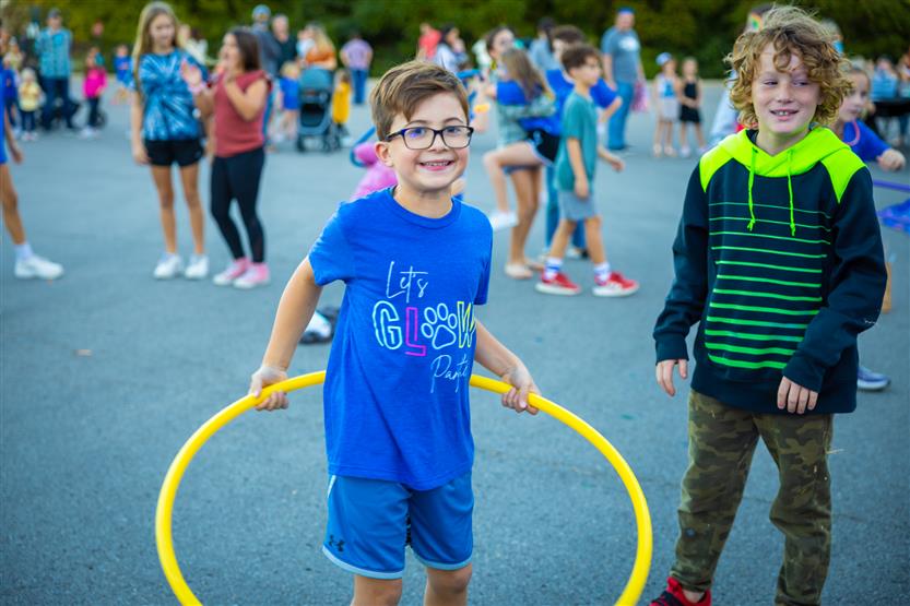A boy holds a hula hoop